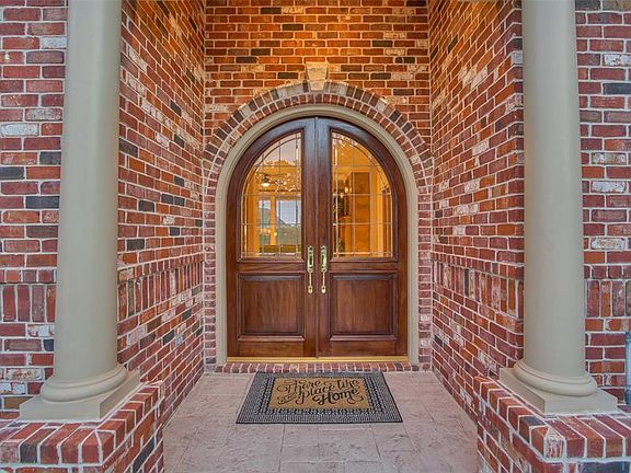 Front entrance boasts of double solid wood front doors and a great porch space to make your own.