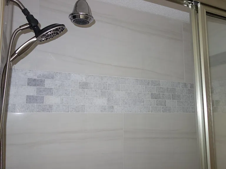 View of shower in 1st bathroom. Double heads!