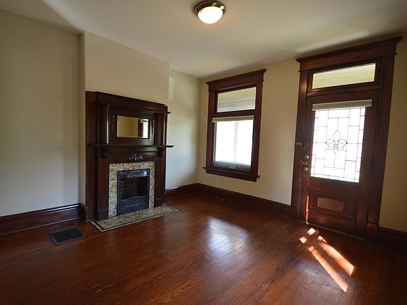 Decorative fireplace with plentiful natural light from south facing windows.