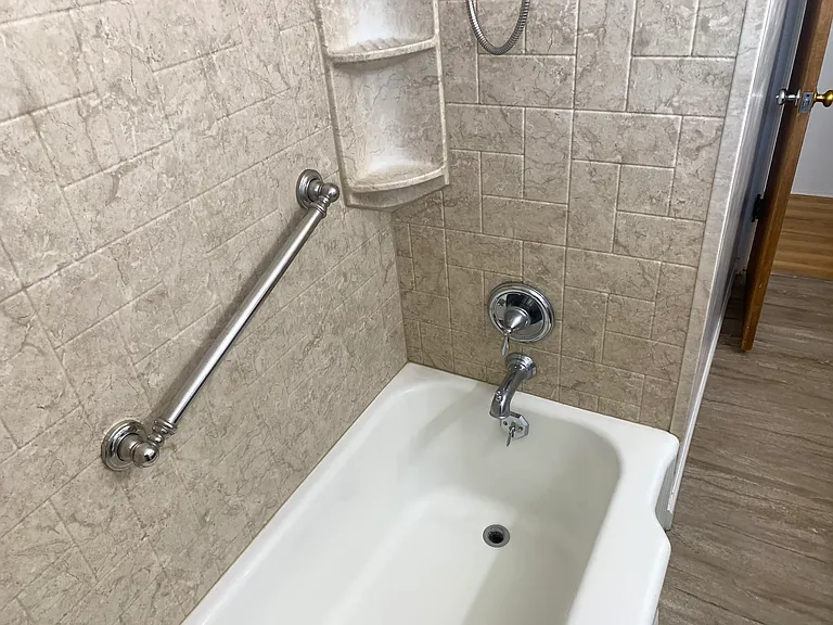 Deep tub, easy to clean surround. Grab bars for safety.