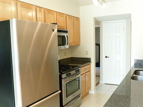The kitchen is both roomy and functional and features recently upgrade maple cabinets and granite counter tops.
