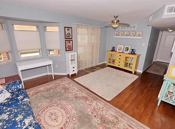 Living room view towards dining area. Laminate flooring through hallway to beds and bath.