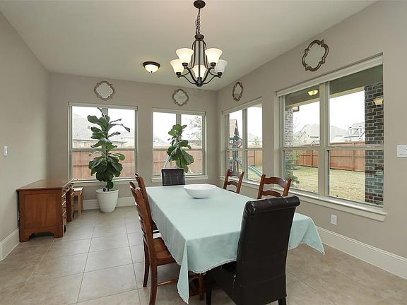 This is the breakfast area Sun Room with such a pretty view of the back yard and patio area. (Upgrade: The fence is stained with