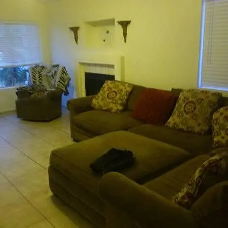 Living room with gas fireplace. Turns on with a flip of a light switch. Shows a sectional and chair fit great !