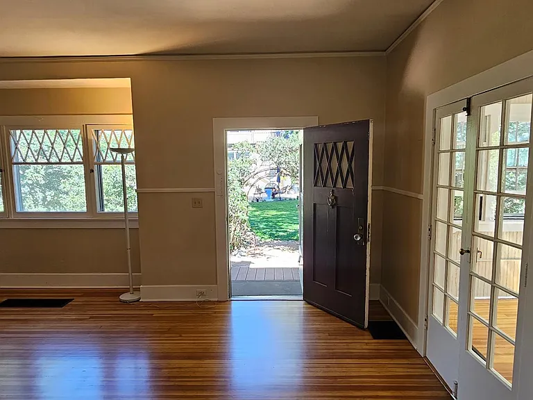 View of living room and entry from hallway