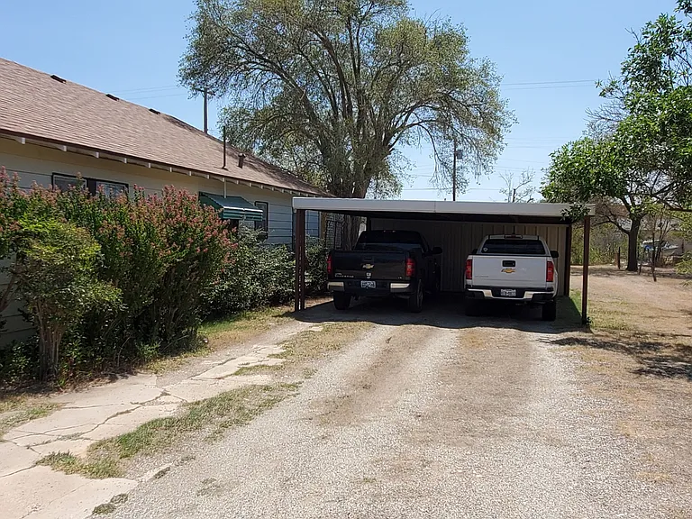 Long driveway with 2 carport parking.
Storage is in the back of carport.