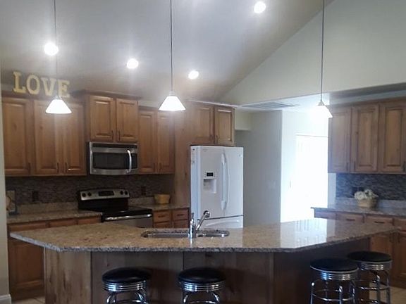 Large island with sink and drawers.