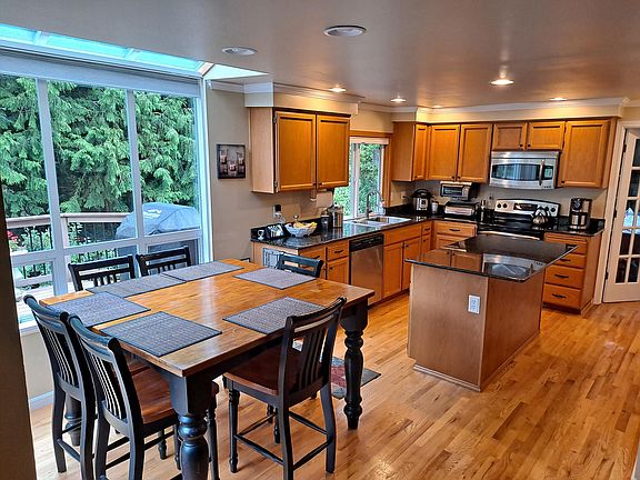 Kitchen and eating area. Appliances are GE Profile stainless steel finish.