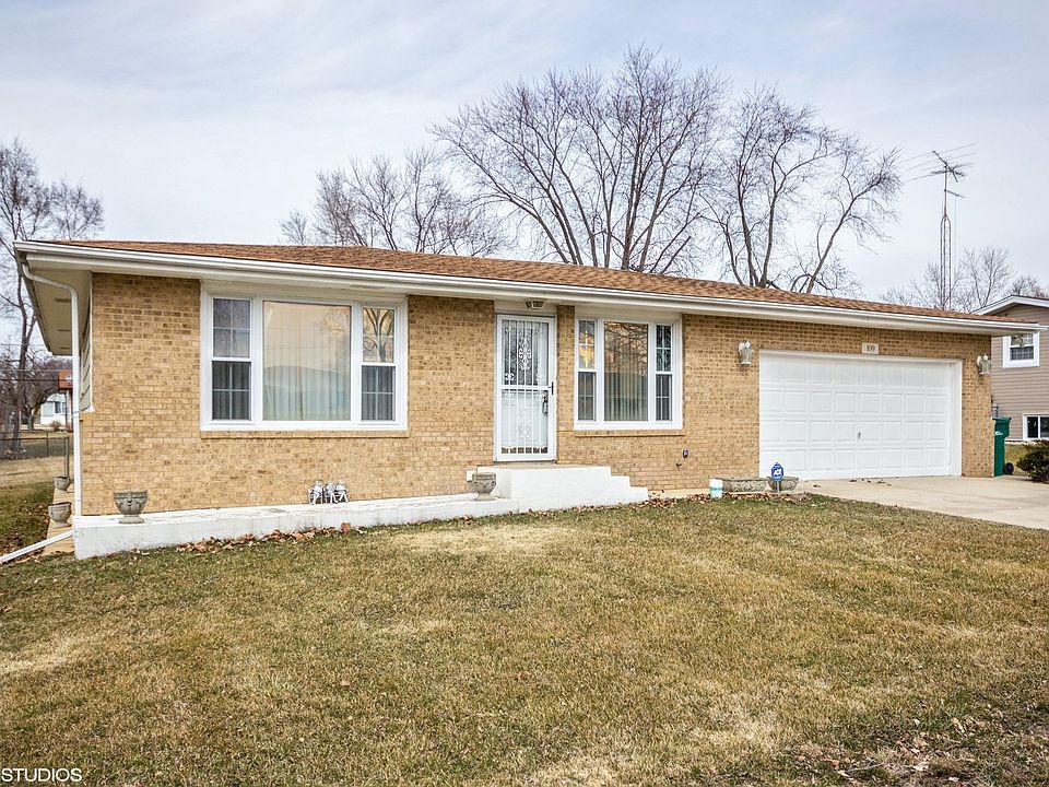 No more snow covered cars with the attached garage with direct entrance to this spacious brick front