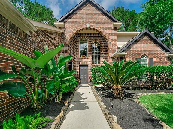 This grand entryway features brick archways, freshly painted accent trim and decorative windows.