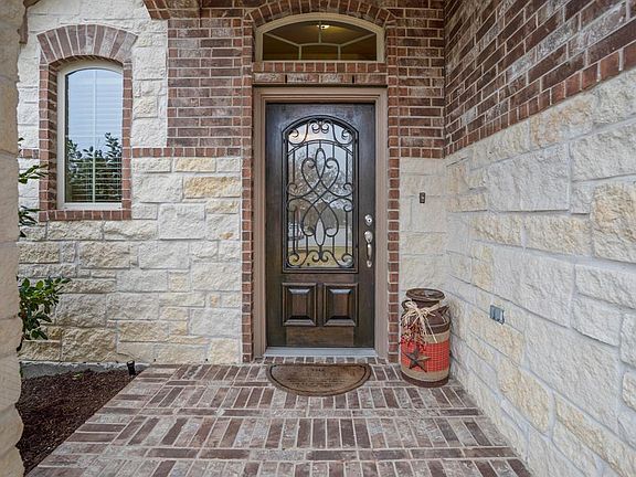 Beautiful brick and stone elevation surround the front of the home. Gorgeous front wrought iron insert door makes an impression as you enter the home.