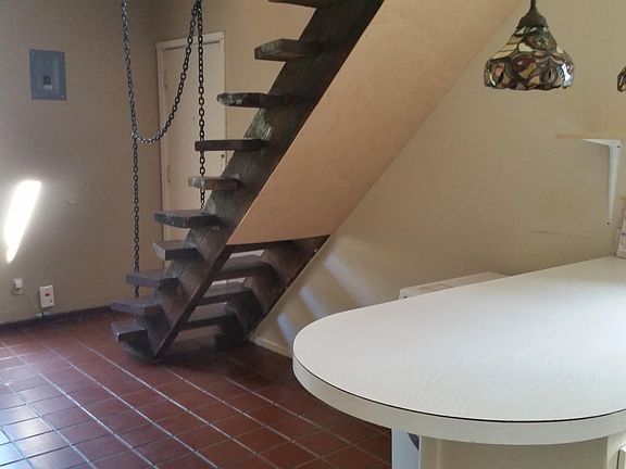 The living room has a breakfast bar and stairs to the upper floor.
