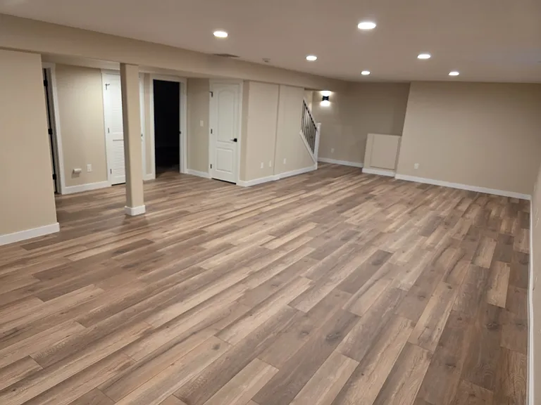 Basement open area with door to First Basement Bedroom