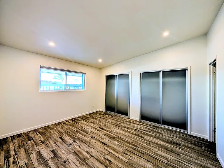 Master Bedroom. Glass sliding closet door. Honeycomb window coverings