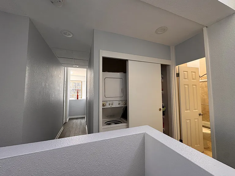 Hallway to two bedrooms, hallway closet with storage space, washer and dryer, hallway bathroom