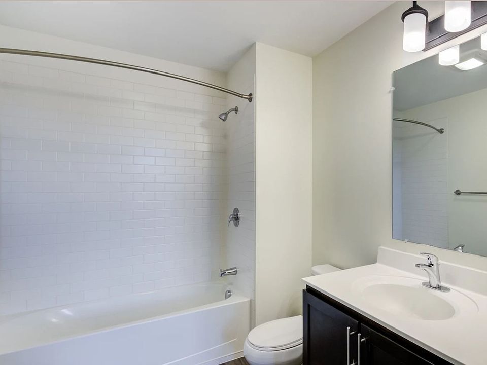 Primary, en suite bathroom features a tub and large vanity