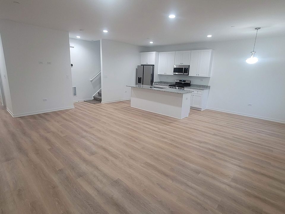 View of great room from patio door. Access to Main door, and starwell going up. Smart WIFI enabled Thermostat and coat closet on entrance to starwell on.