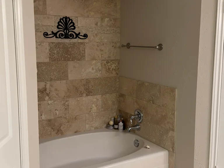 bathtub is flanked on both sides by walk-in closets