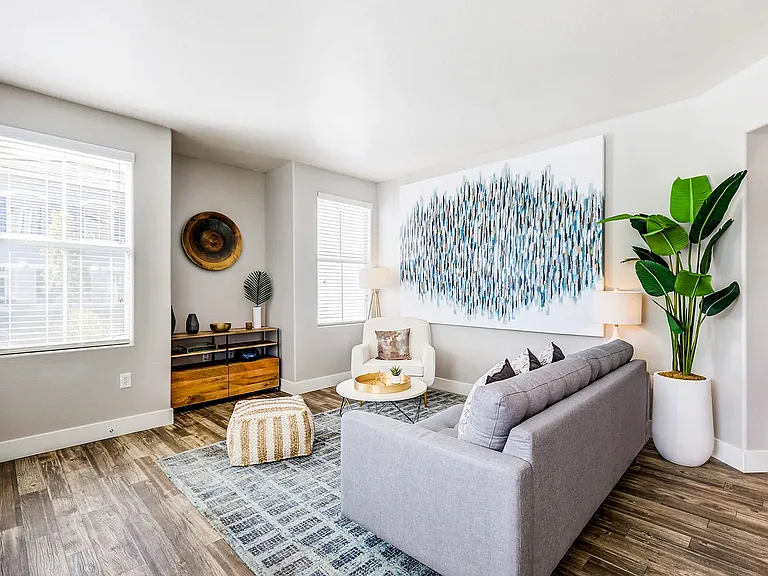 Experience comfort and style in this sunlit modern living room, perfect for relaxation and entertaining.