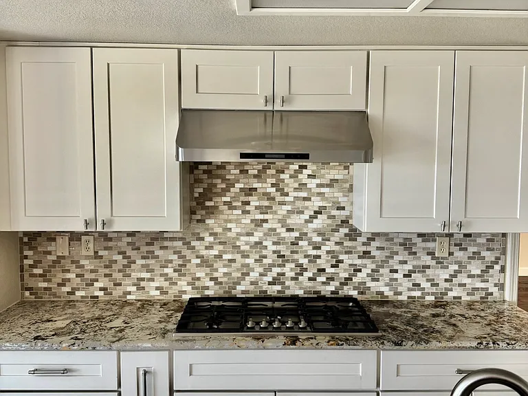 Chef-style 5-burner stove paired with a decorative backsplash