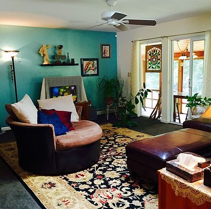 Living Room : Carpeted, skylight, sliders open onto screened porch