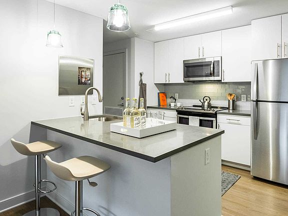 Kitchen with Stainless Steel Appliances and Quartz Countertops. Furnishings by Room & Board
