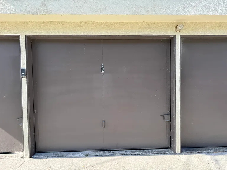 Private garage with additional room for storage at front of garage.