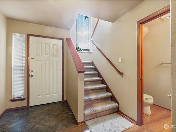 Front door near stairs and 1/2 bath>
