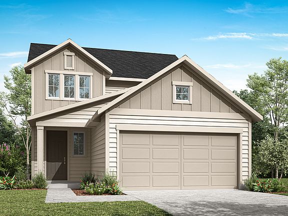 A two-story beige house with a black roof, a garage, and a well-manicured lawn surrounded by trees i