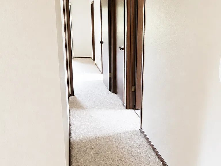 Hallway to primary and second bedrooms
