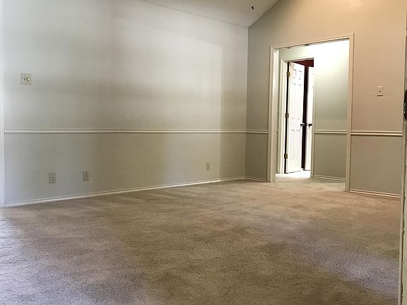 You walk in at the front of the house to a large living area with nice beams and high ceilings.