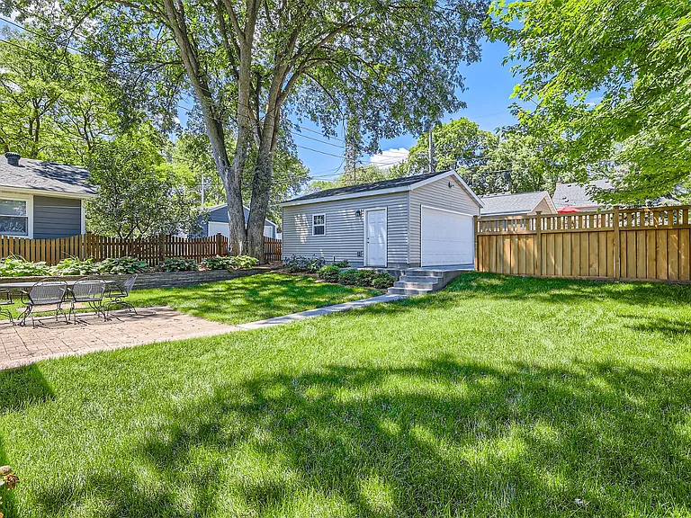 Spacious backyard with 2 car detached garage and additional parking pad- an entertainers dream.