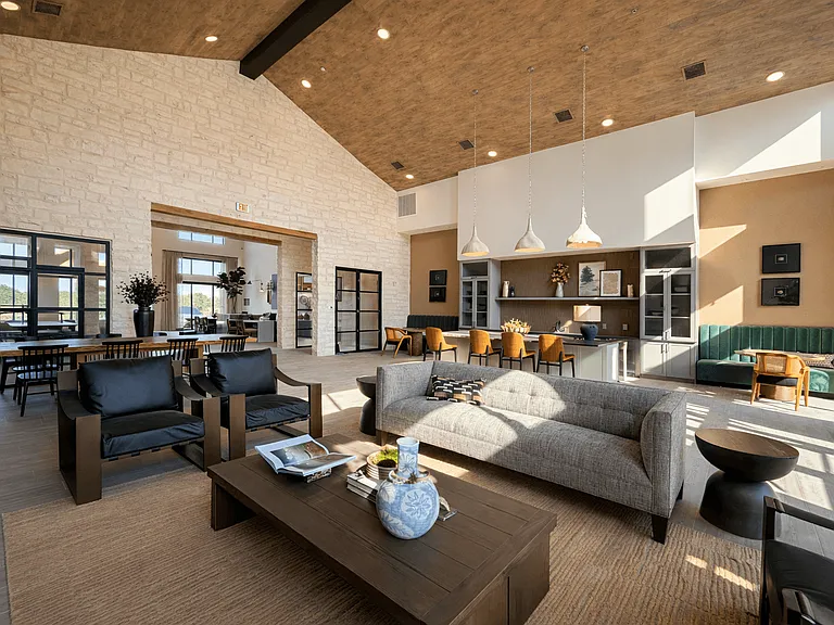 An inviting resident lounge with comfortable seating, open gathering areas, and warm design detailsperfect for relaxing or hosting friends.
