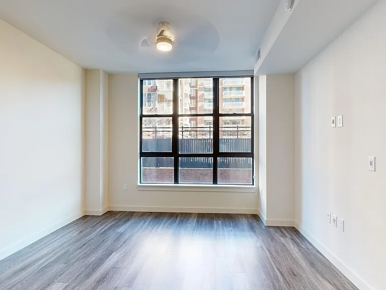 Apartment living room with wood-style flooring.