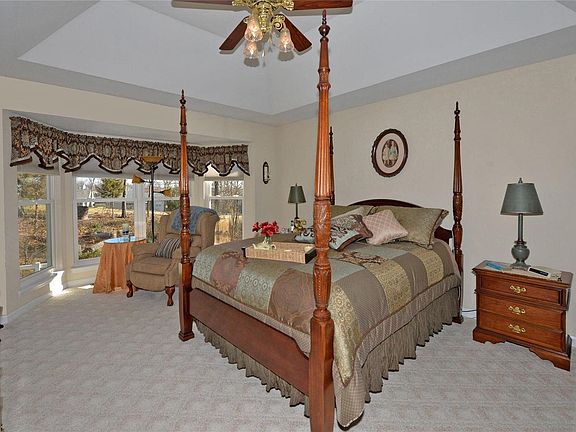 Those bay windows are a real treat in this spacious master bedroom. Another coffered ceiling and lighted fanadd even more interest.