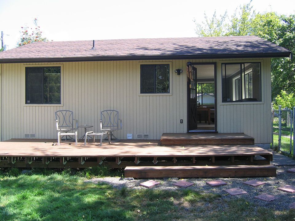 View of back door from the large fenced yard
