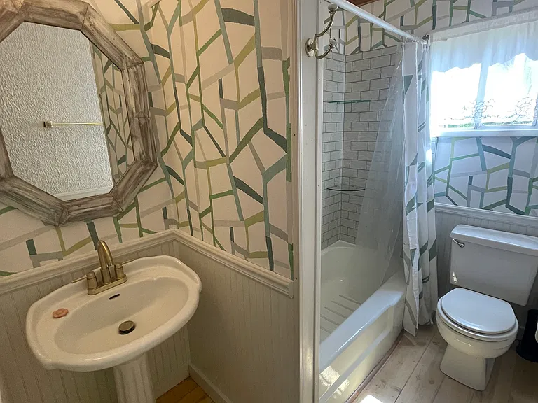 attached bath with newly tiled shower