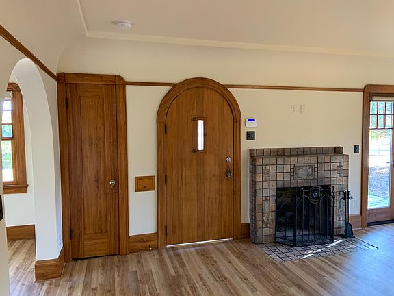 Living Room, facing the front door, Batcheldor-tiled fireplace, and coat closet
