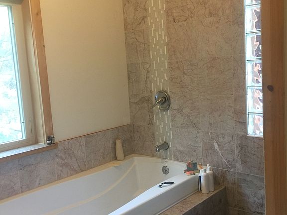 Huge tub, tiled shower