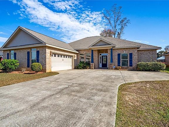 View of front of house with a garage and a front lawn