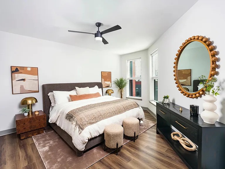 A bright and airy bedroom retreat featuring oversized windows, hardwood-style flooring, and contemporary finishes.