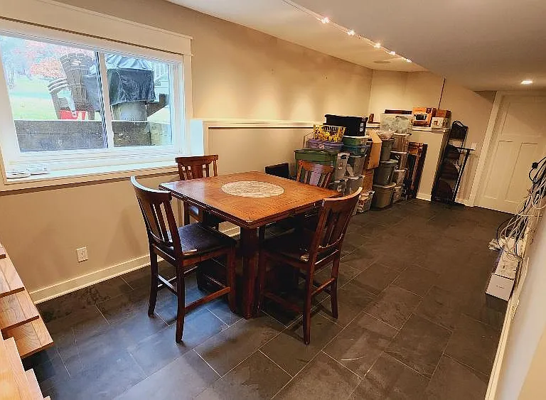 Basement open area. Bedroom in background.