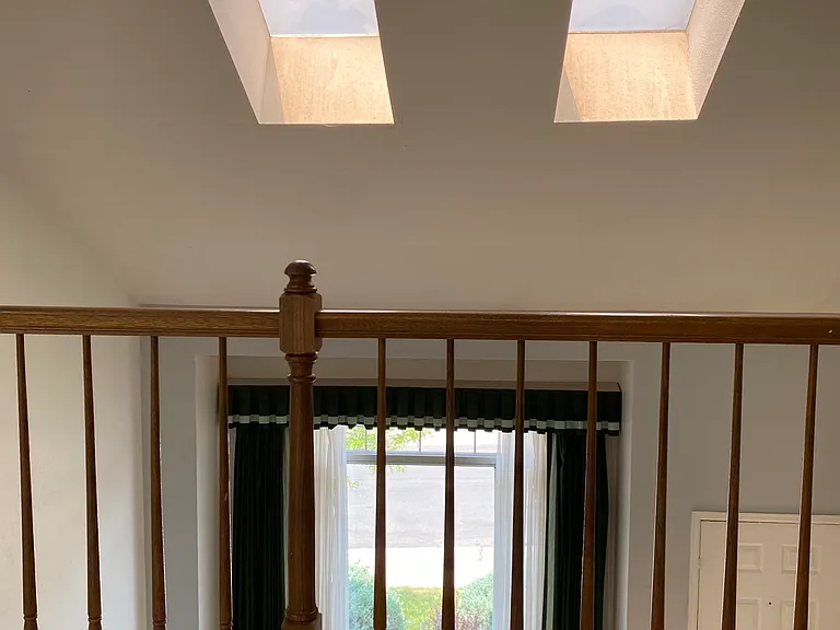 Upstairs loft looking down at front door.