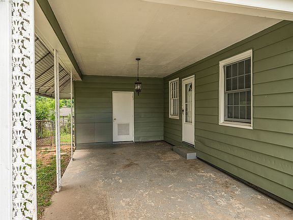 1-car carport with access to kitchen on the right, storage and dryer hook-up in the storage closet