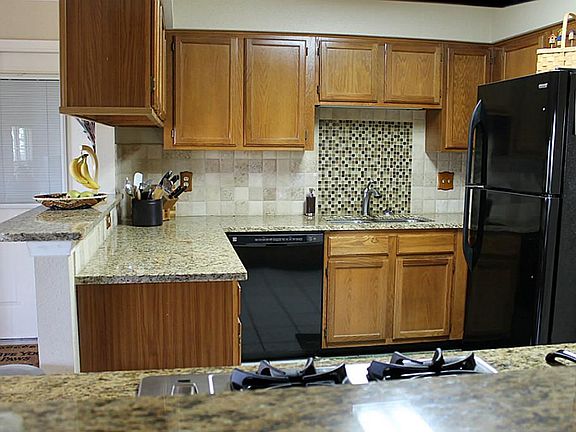 Recently updated kitchen features granite countertops and tile backsplash.