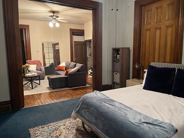 Looking from Front BedRoom back into Livingroom thru open Pocket Doors, shows Woodwork and open Half Bath Door to the Right