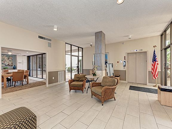 Lobby with view of elevator to top floor. Side entrances from back parking.
