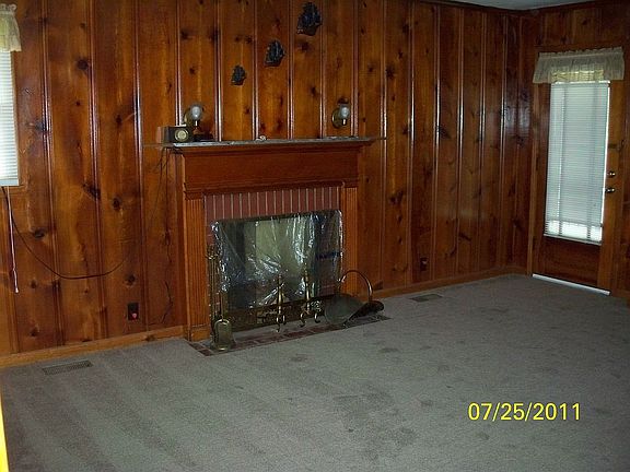 paneled den with fireplace