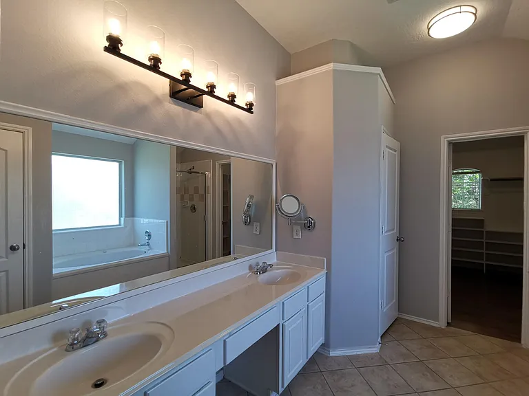 Master bath with double vanities, new lights, jet bathtub and separate shower