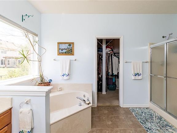Large master bath with dual vanities, large shower, garden tub and huge his and hers walk in closet